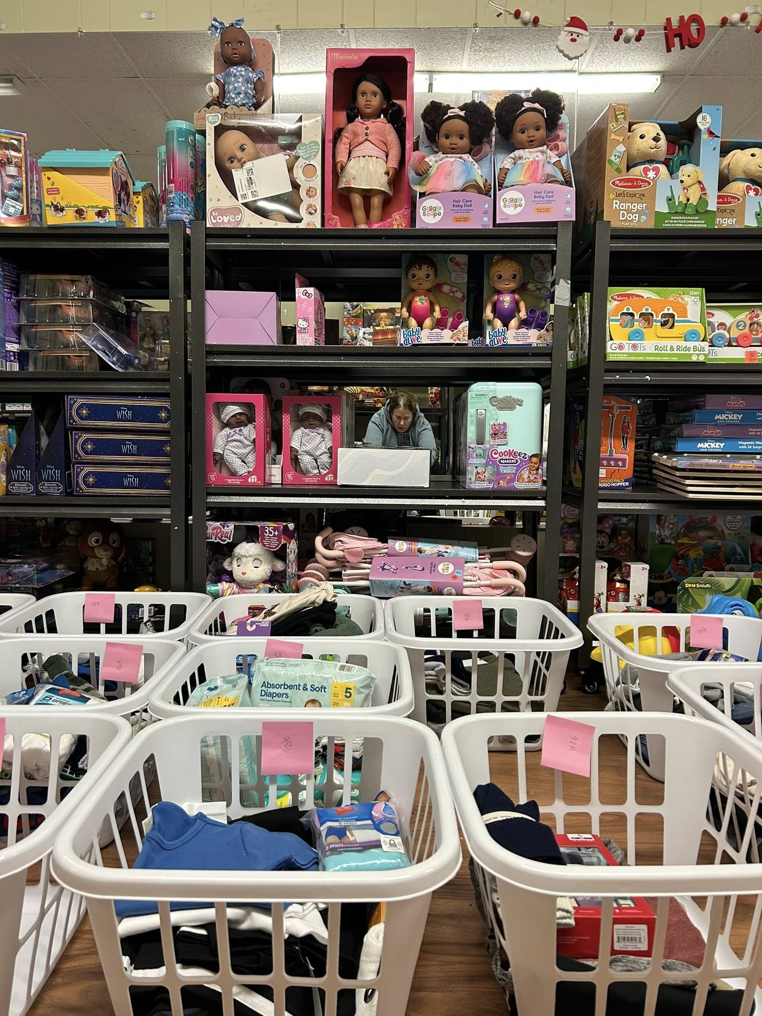 Shelves stocked with dolls and toys for children